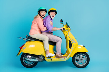 Fototapeta na wymiar Full size profile side photo of happy cheerful old couple ride bike journey isolated on pastel blue color background