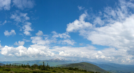 Panorama of the Carpathian mountains at the beginning of summer in Ukraine, rest and travel in the mountains