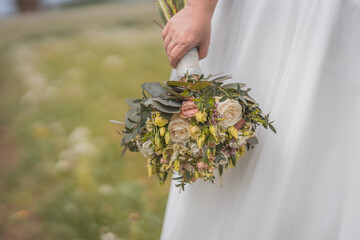 person holding a bunch of  weddingflowers