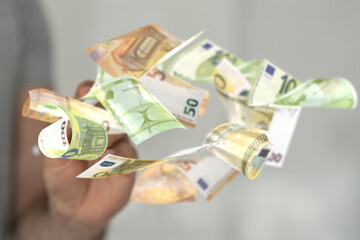 euro bills flying around  in hand