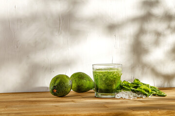 Green drink on desk and wall with shadows 