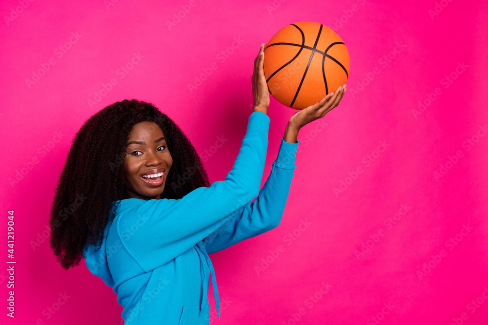 Poster photo of funky pretty dark skin woman dressed blue sweatshirt smiling playing basketball isolated pi