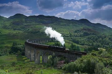 The Jacobite train crossing Glenfinnan Viaduct, Highlands, Scotland.