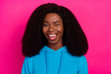 Photo of impressed flirty dark skin lady wear blue hoodie open mouth winking smiling isolated pink...