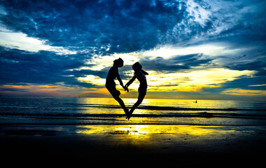 silhouette of heart at beach 