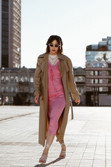 Beautiful young caucasian woman wearing trench coat