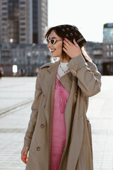 Fototapeta premium Beautiful young caucasian woman wearing trench coat