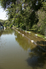 Public park drenched in rain. Water logged park.Wet benches. Park filled with water after...
