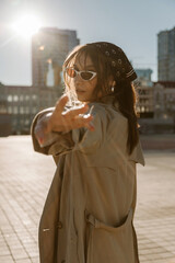 Fototapeta premium Beautiful young caucasian woman wearing trench coat