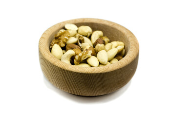 Mixed nuts in wooden bowl isolated on white background