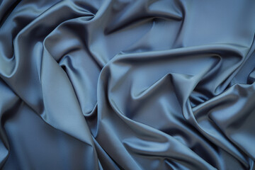 Obraz premium Elegant soft abstract gray background. Delicate silk waved fabric with copy space for design projects. Toned image.