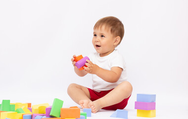 Little boy playing with building blocks, isolated