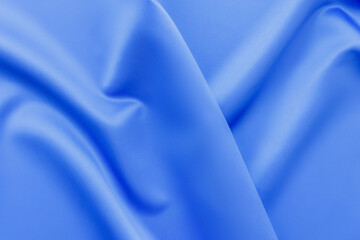 Elegant soft abstract light blue background. Delicate silk waved fabric with copy space for design projects