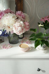 Bouquet of pink peonies on the dresser in the bedroom