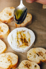 DIY baked cheese camembert instruction step by step. step 4 add olive oil. cheese with white mold.moldy cheese.