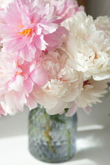 Bouquet of pink peonies on the dresser in the bedroom