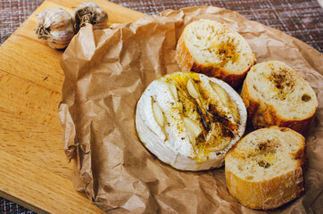 homemade DIY baked camembert with garlic.cheese with white mold.baked cheese.