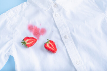 close up dirty stain of strawberry on a white shirt. 