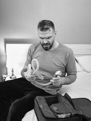 Unhappy shocked man with chronic breathing issues surprised by using  CPAP machine sitting on the...