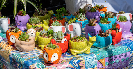 A display of small animal ceramic planters at a stall in a farmers market in Salem Oregon