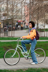 African american woman riding bicycle on urban street