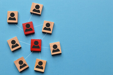 Wooden blocks with people icons connected by lines