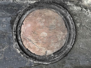 antique rosette on the wall of a medieval Italian building