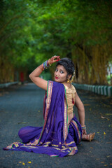 Indian Traditional Beautiful young girl in saree posing outdoors