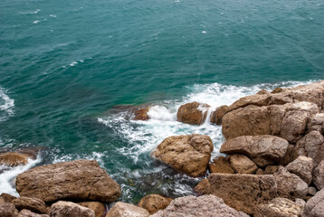 Seascape of the Crimean coast. Waves break into beautiful splashes against rocks.