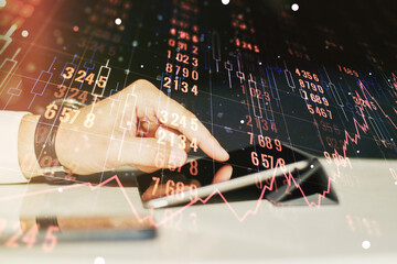 Multi exposure of abstract graphic data spreadsheet sketch and hand working with a digital tablet on background, analytics and analysis concept