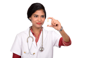 Female Doctor showing the tube of medicine on white background