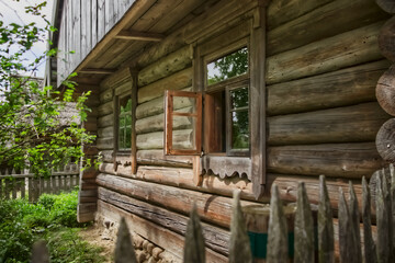 The architecture of the Belarusian village of the 19th century. Wooden buildings in the green of the natural landscape.