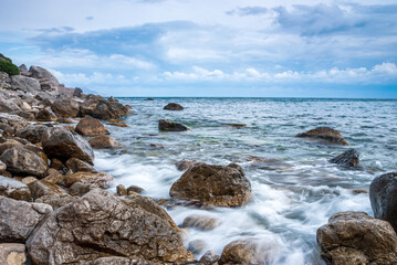 Seascape of the Crimean coast. Waves break into beautiful splashes against rocks.