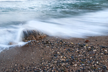 Seascape of the Crimean coast. Waves break into beautiful splashes against rocks.