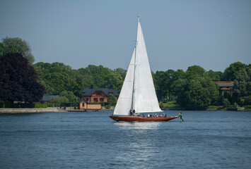 Old sailing ship with sails passing the island Djurg&aring;rden in Stockholm