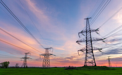 power line pylons during sunset with beautiful saturated sky.
