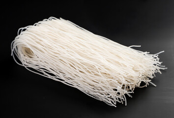 Rice vermicelli on a black background. Funchoza