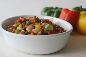 Cauliflower florets marinated fried and sauteed in sauces with onions and bell peppers. An Indo Chinese starter dish. Locally known as Gobi Manchurian.