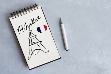 The concept of July 14 is Bastille Day. A notebook with the inscription on July 14 and a drawing of...