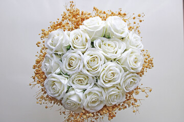 White bridal flower in front of white background. Bride and wedding concept. 