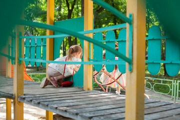 Obraz premium Children play in the playground. Amusement park. Leisure activities of little friends in the park.