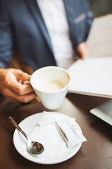 Close up view of businessman holding cup of coffee
