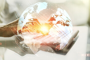 Double exposure of abstract digital world map and hand typing on laptop on background, research and...