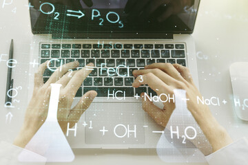 Creative chemistry hologram with hands typing on computer keyboard on background, pharmaceutical research concept. Multiexposure