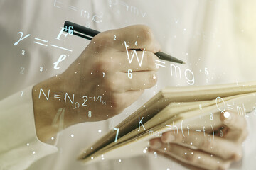 Double exposure of creative scientific formula concept with man hand writing in notebook on background, research and development concept