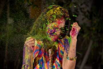 Portrait of a happy young girl with a colorful face on the occasion of Holi color festival.