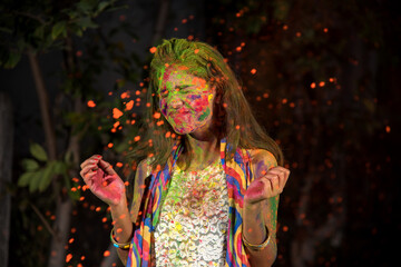 Fototapeta premium A young girl plays with colors. The concept for Indian festival Holi. color splash.