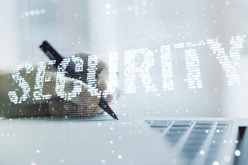 Cyber security creative concept with hand writing in notepad on background with laptop. Double exposure