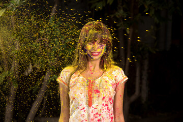 Young girl plays with colors on the occasion of Holi. Concept for Indian festival Holi. color splash.