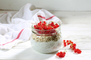 Cottage cheese dessert with chia, strawberries and currants on a white background